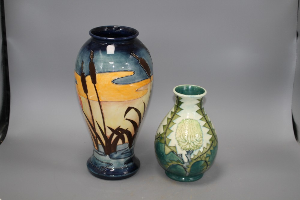 Two modern Moorcroft vases, one decorated with bulrushes and sunset, height 31cm, the other with stylised dandelions, height 19cm